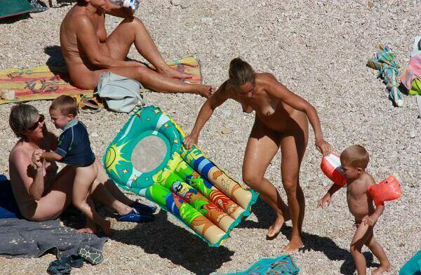 Nudists sunbathe on a beach [Pure naturism]