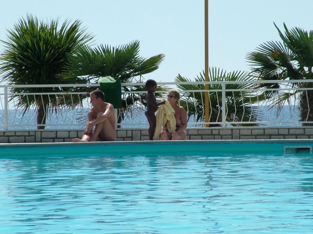 Photo of naturists in an outdoor pool - Nudity is an integral part of life in nature